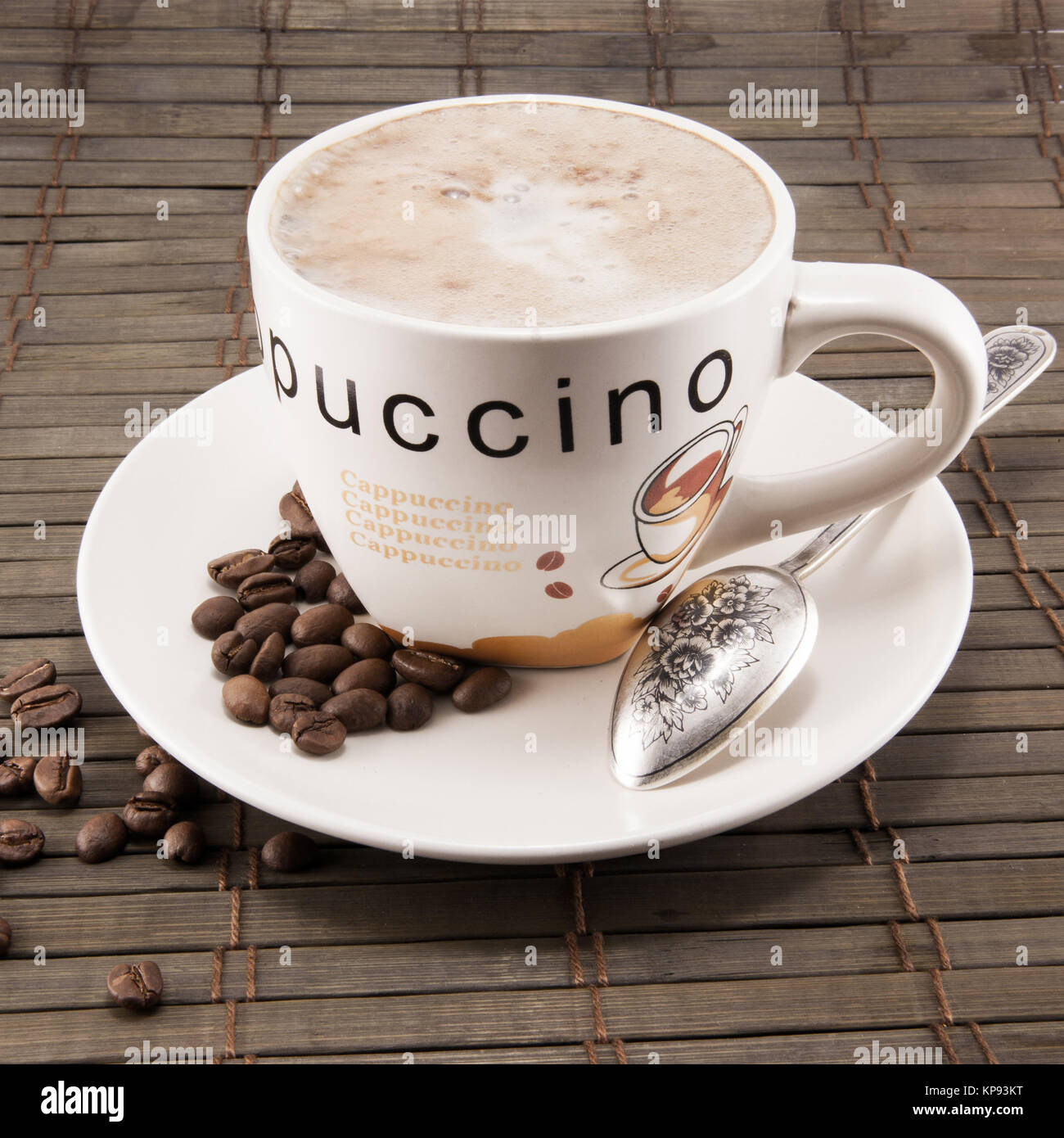 Cup of Lavazza Latte coffee in white china cup with white saucer in  daylight with froth foam on top and biscuit and teaspoon Stock Photo - Alamy