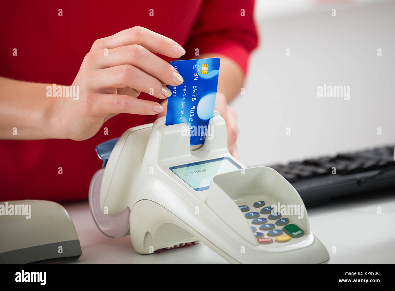 Saleswoman Swiping Credit Card On Reader Stock Photo