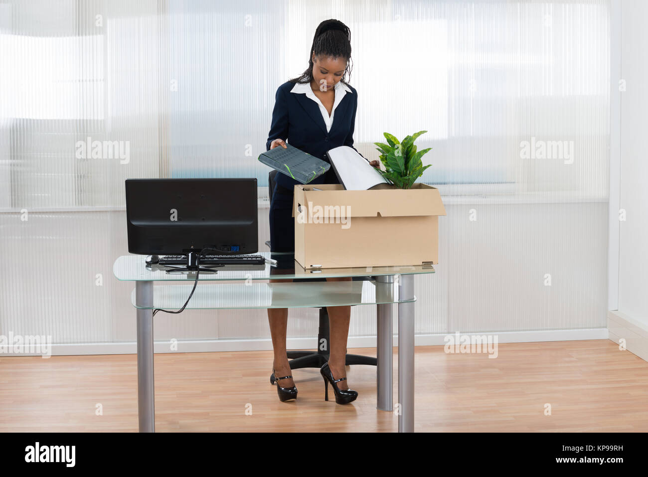 Businesswoman Putting Her Belongings In Box Stock Photo - Alamy