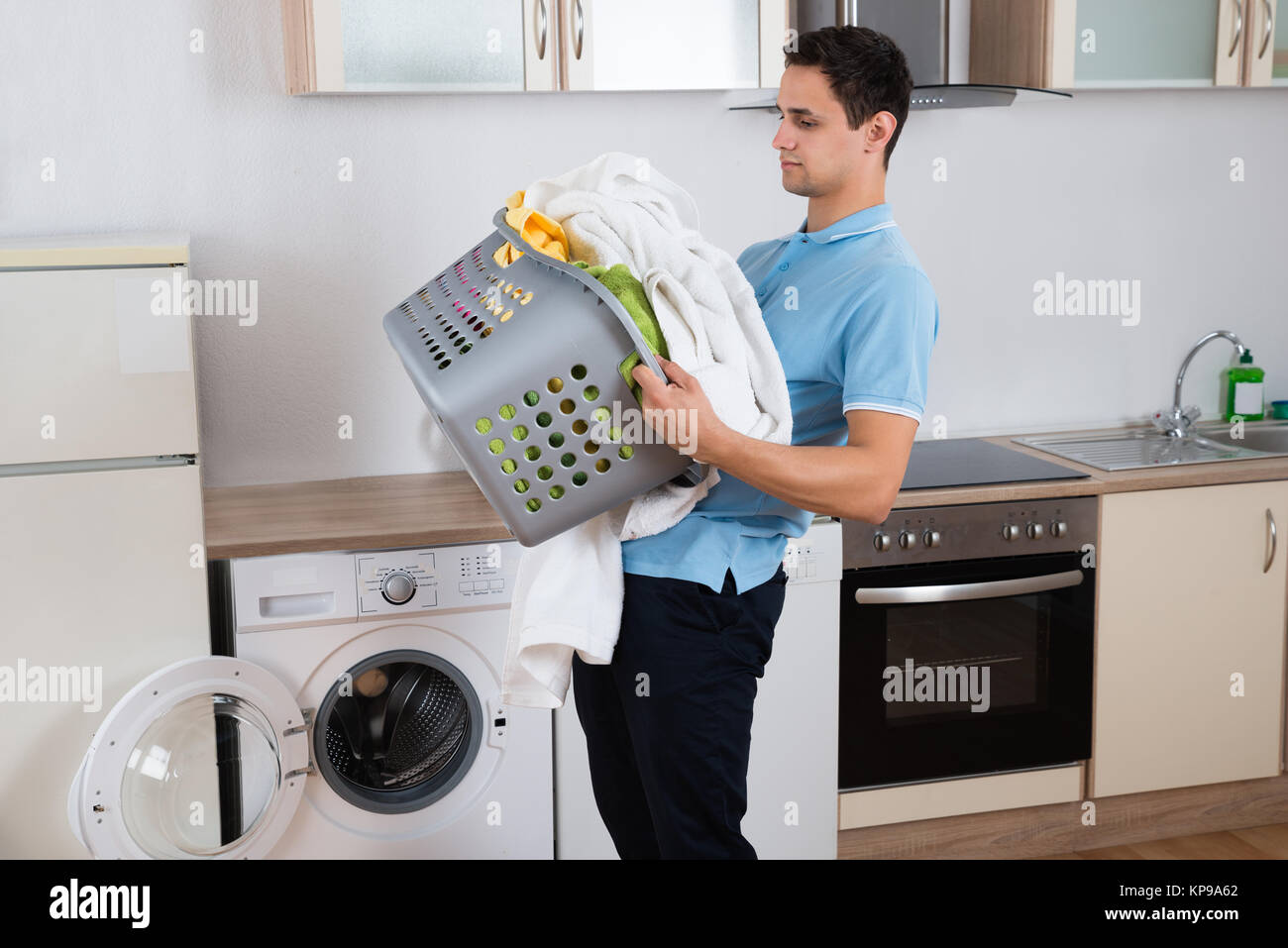 Man Carrying Heavy Laundry Basket Stock Photo Alamy