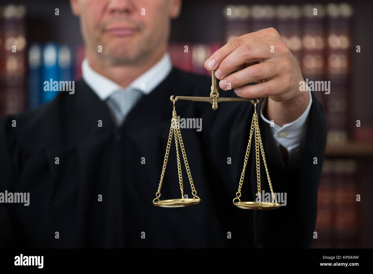 Judge Holding Law Scales In Courtroom Stock Photo Alamy
