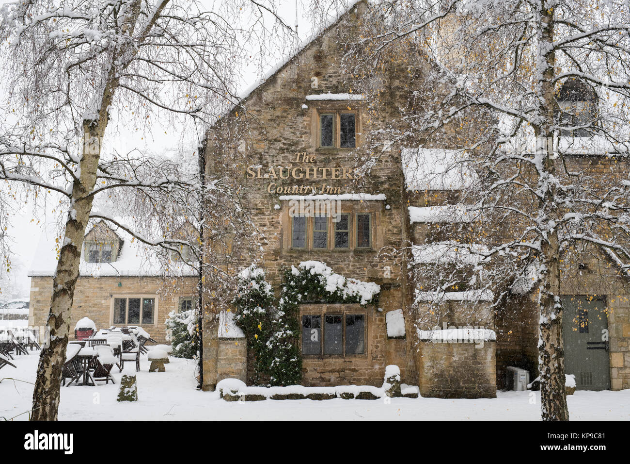 The Slaughters country inn whilst its snowing in December. Lower Slaughter, Cotswolds, Gloucestershire, England Stock Photo