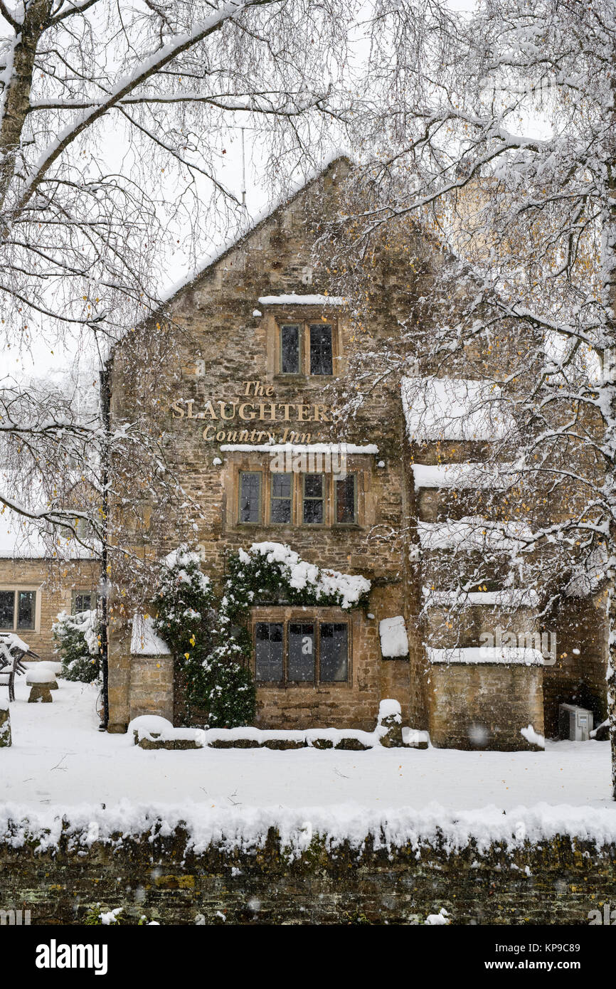 The Slaughters country inn whilst its snowing in December. Lower Slaughter, Cotswolds, Gloucestershire, England Stock Photo