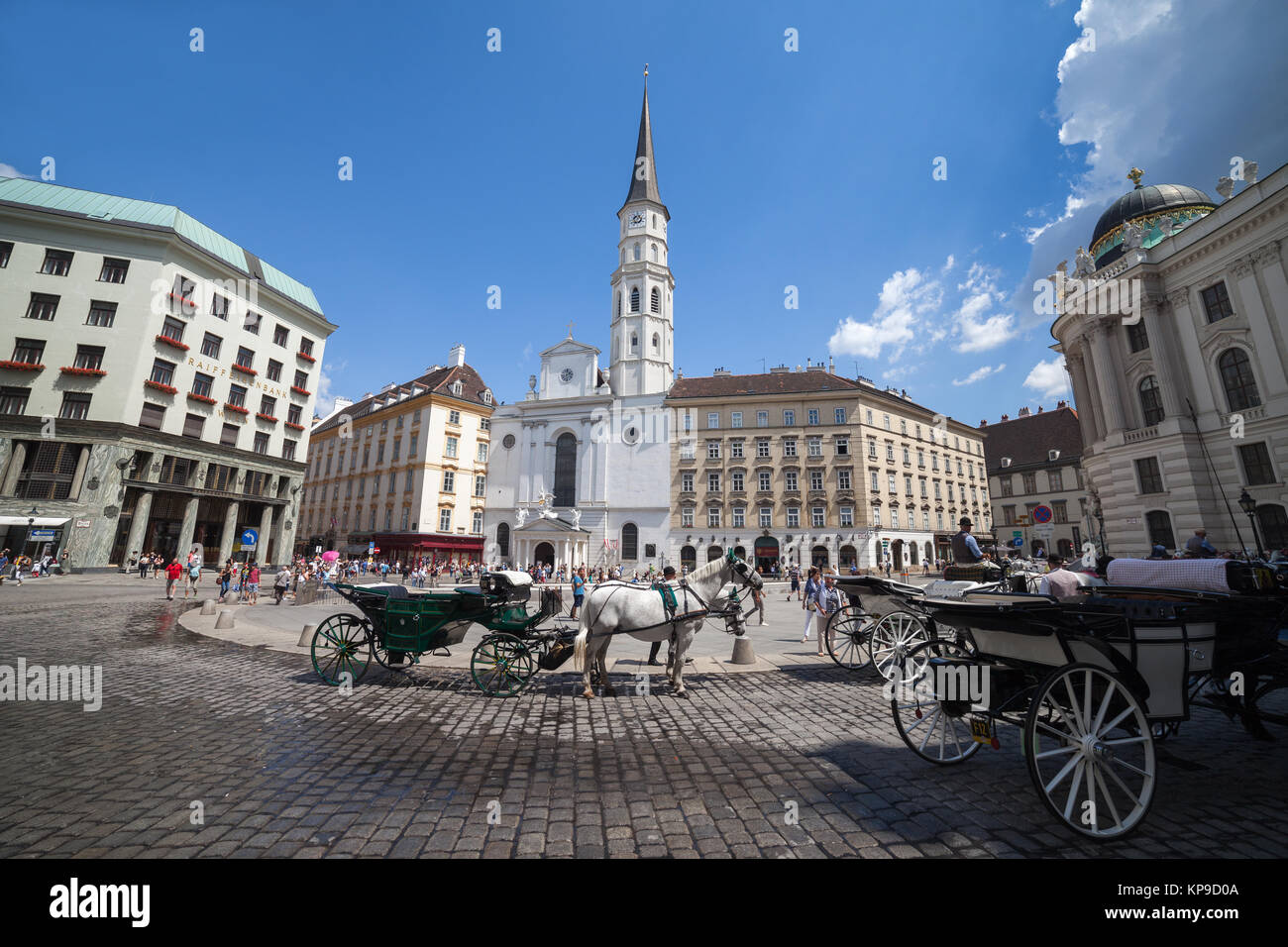 Horse carriages for tourists sightseeing tour on Michaelerplatz - St. Michael's Square in city of Vienna, Austria, Europe Stock Photo