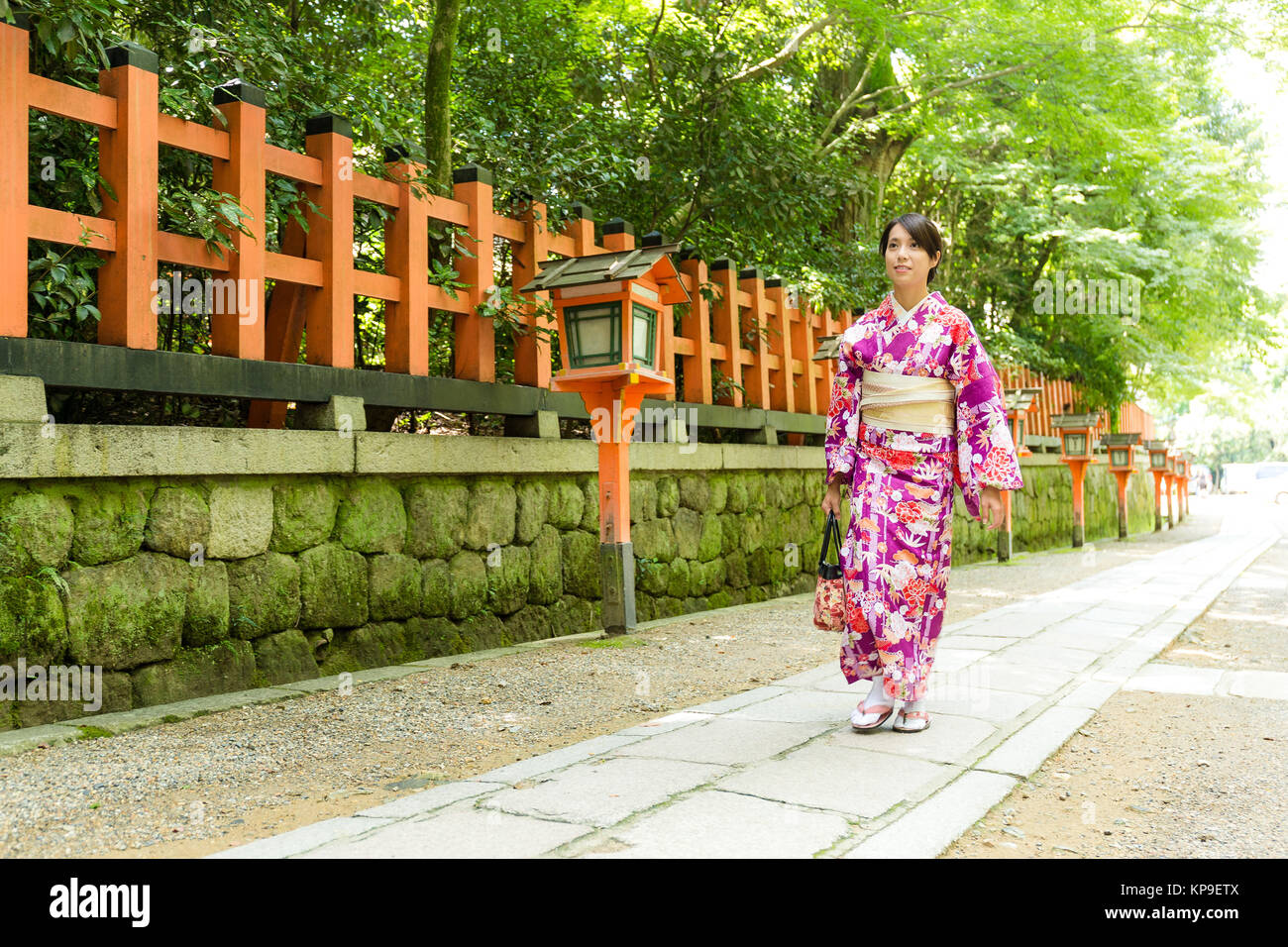 Young Woman wearing the kimono dress and walking the street Stock Photo