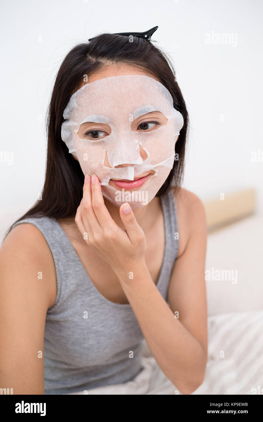 Young woman use of the facial mask in bed Stock Photo Alamy