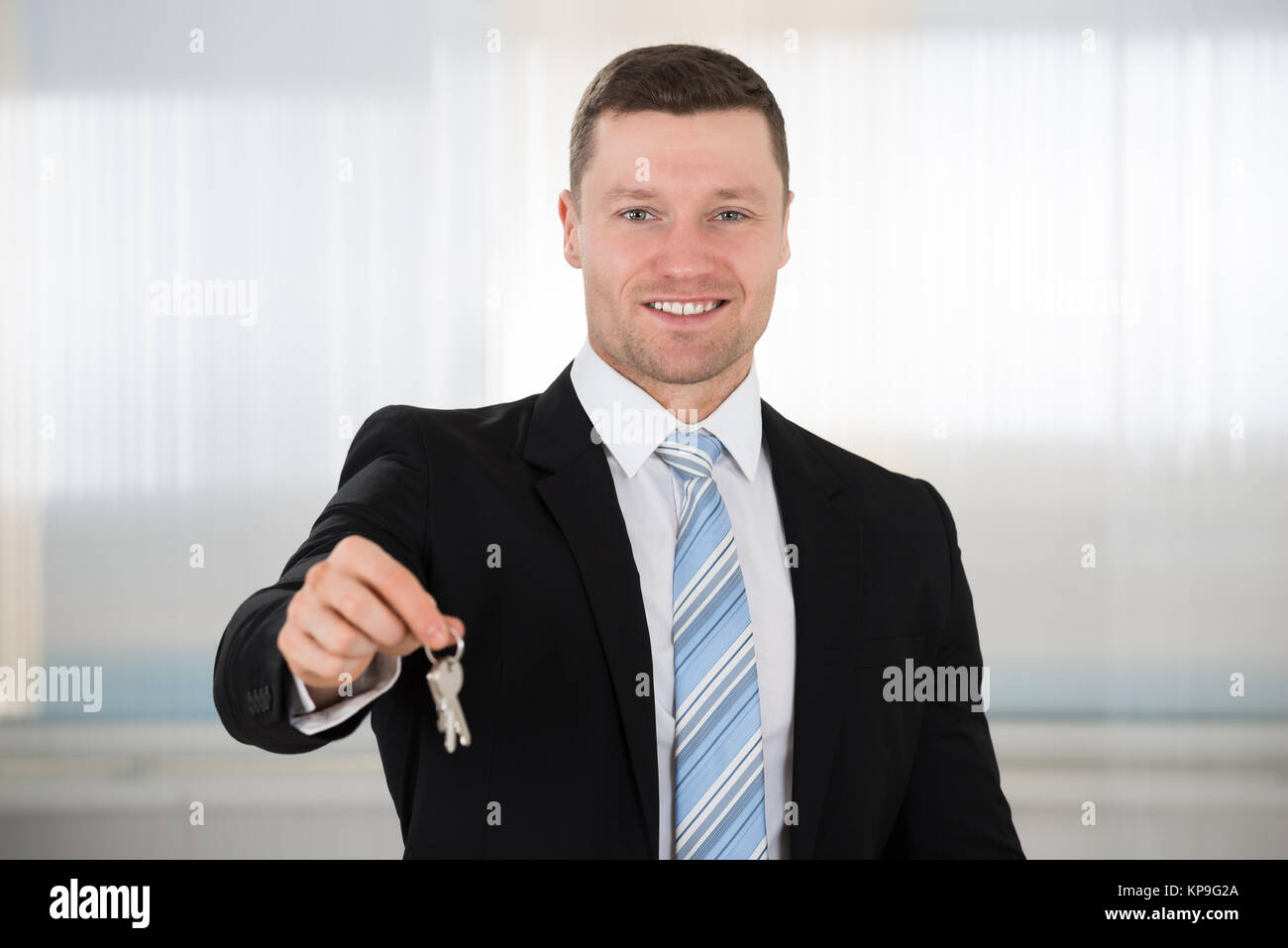 Happy Real Estate Agent Giving House Keys Stock Photo - Alamy