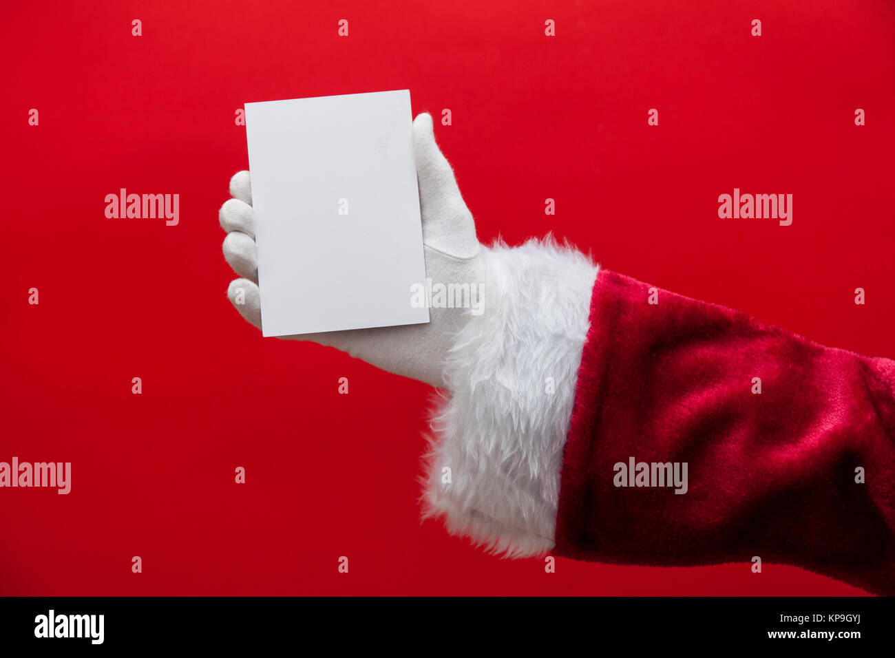 Santa Claus hand holding a blank white sign Stock Photo - Alamy