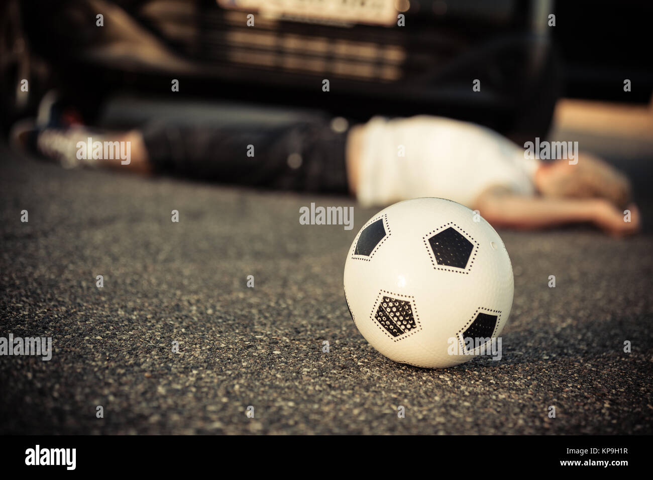 Young boy playing soccer hit by a car Stock Photo Alamy