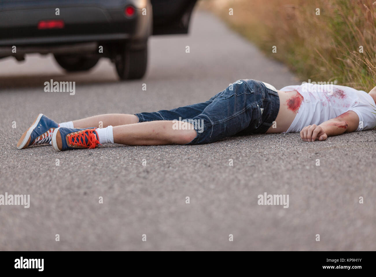 Young boy run over by a car Stock Photo
