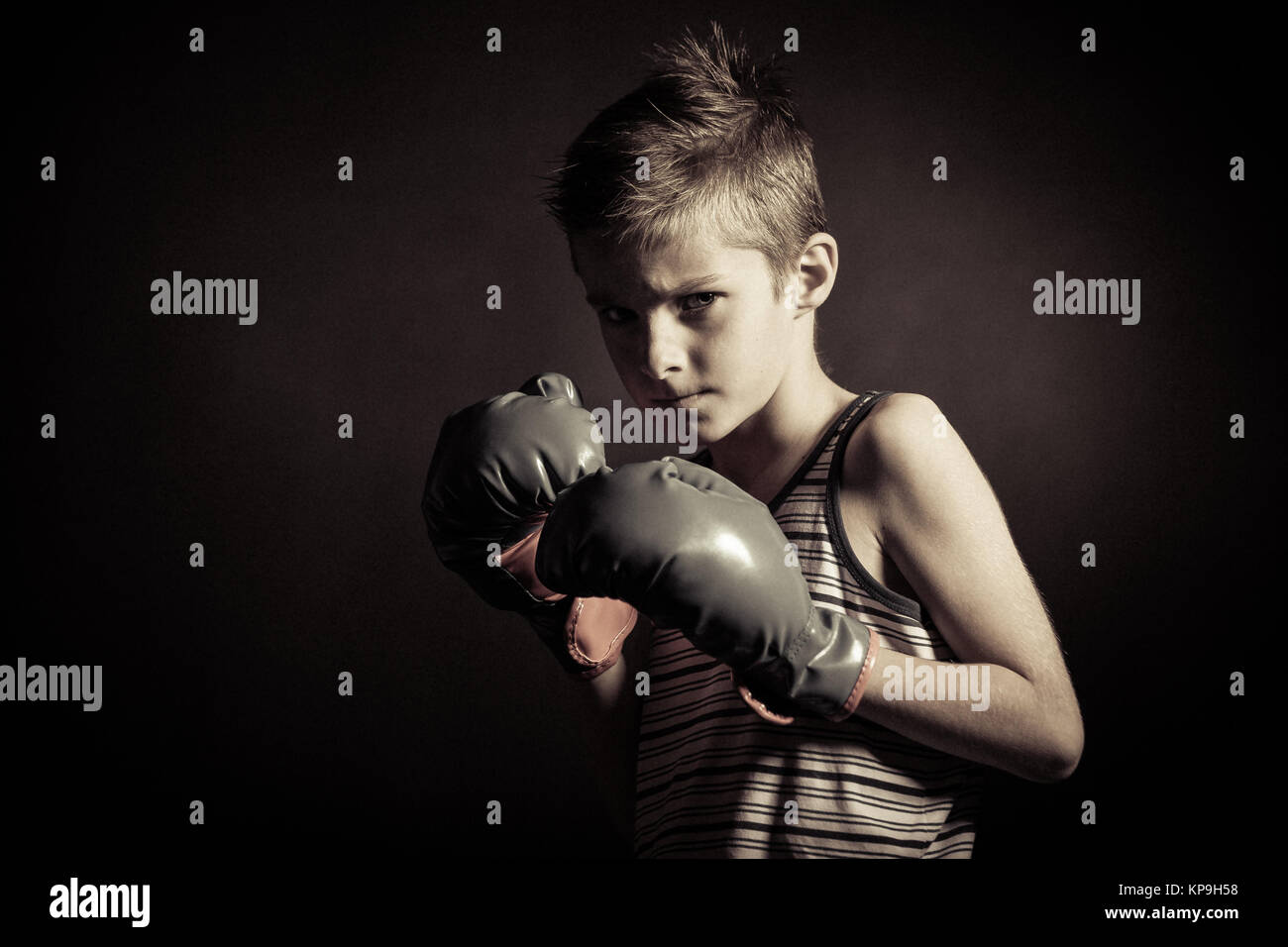 Boxer Boy with Gloves Frowning at the Camera Stock Photo