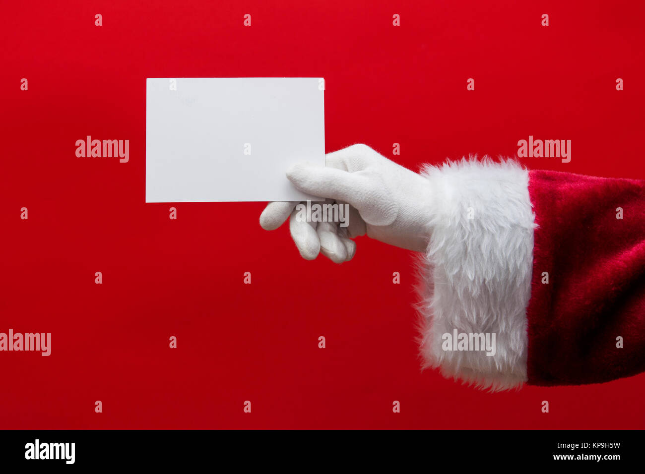 Santa Claus hand holding a blank white sign Stock Photo - Alamy