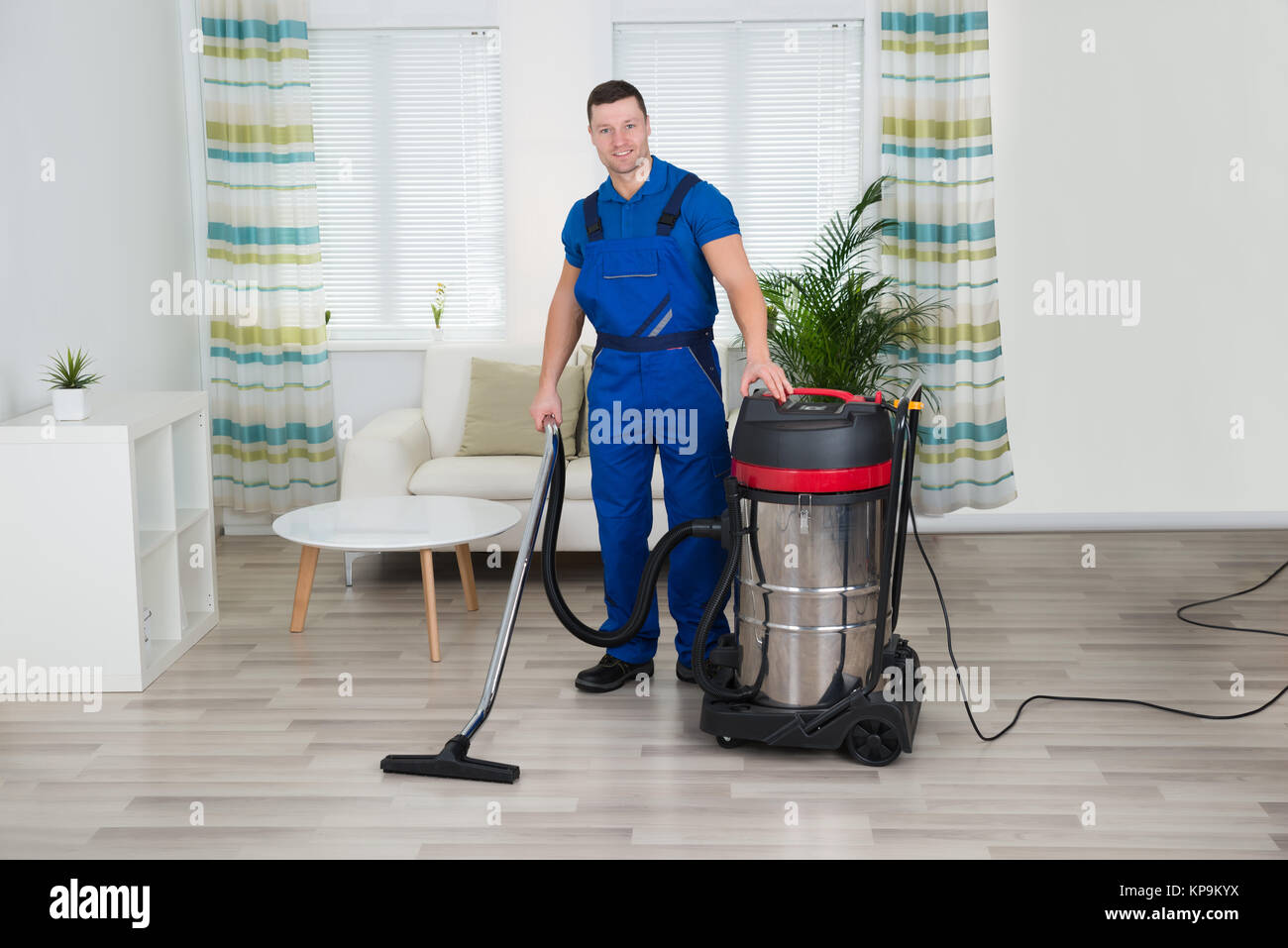 Worker Cleaning Floor With Vacuum Cleaner At Home Stock Photo Alamy
