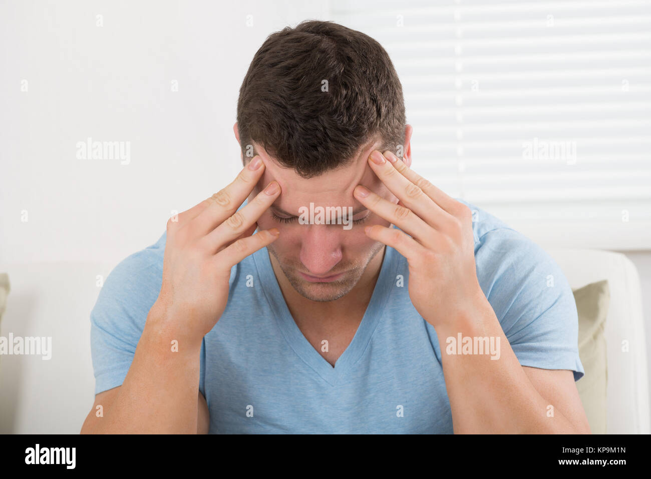 Man Suffering From Headache At Home Stock Photo - Alamy