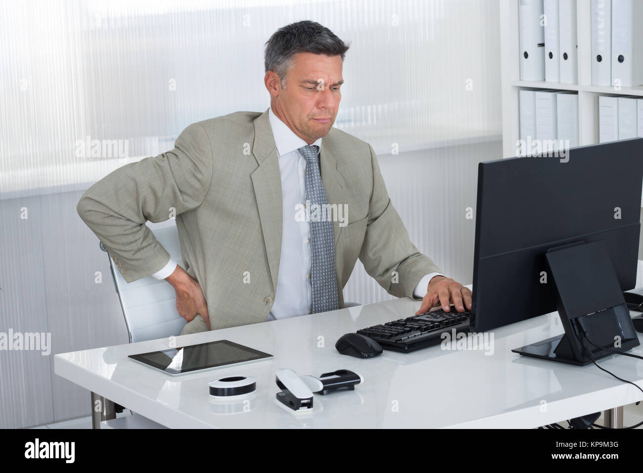 Mature Businessman Suffering From Back Pain At Desk Stock Photo Alamy