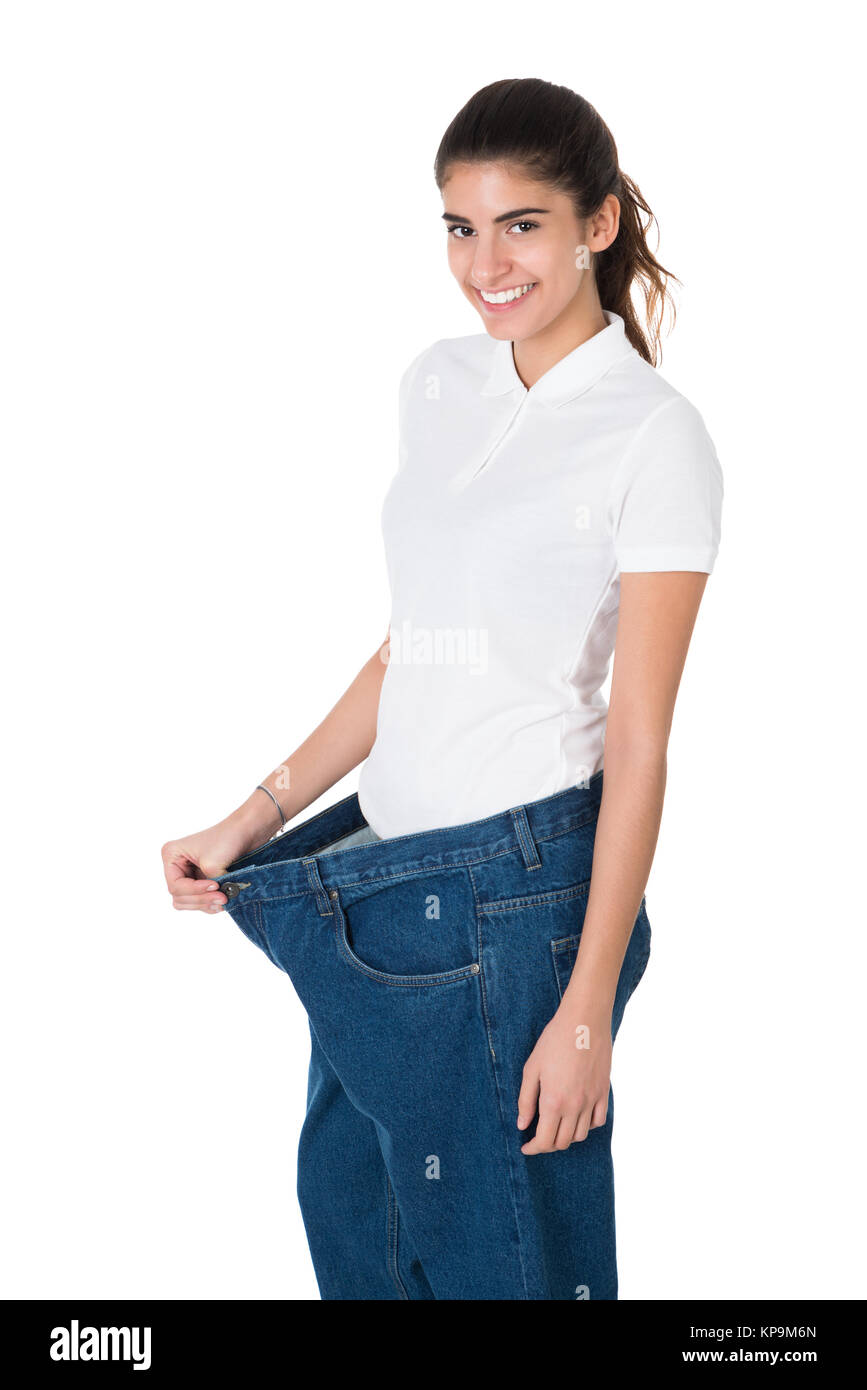 Smiling Woman Showing Her Old Jeans After Successful Diet Stock Photo ...