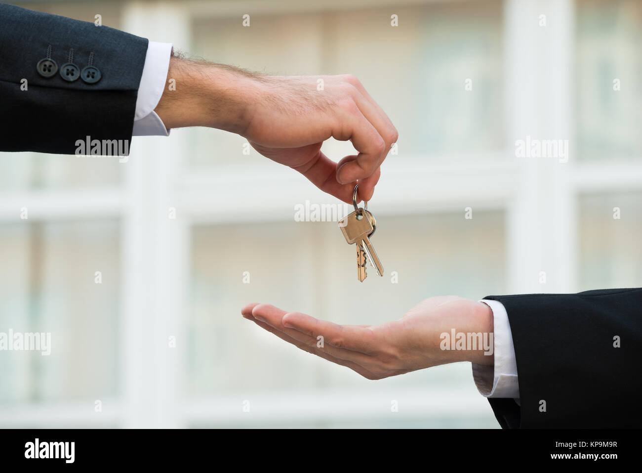 Real Estate Agent Giving House Keys To Businessman Stock Photo - Alamy