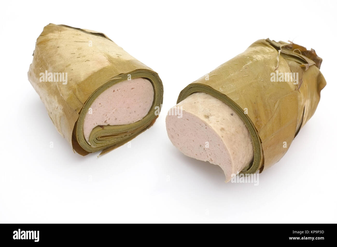 Vietnamese steamed pork sausage wrapped under banana leaf, two half roll Stock Photo