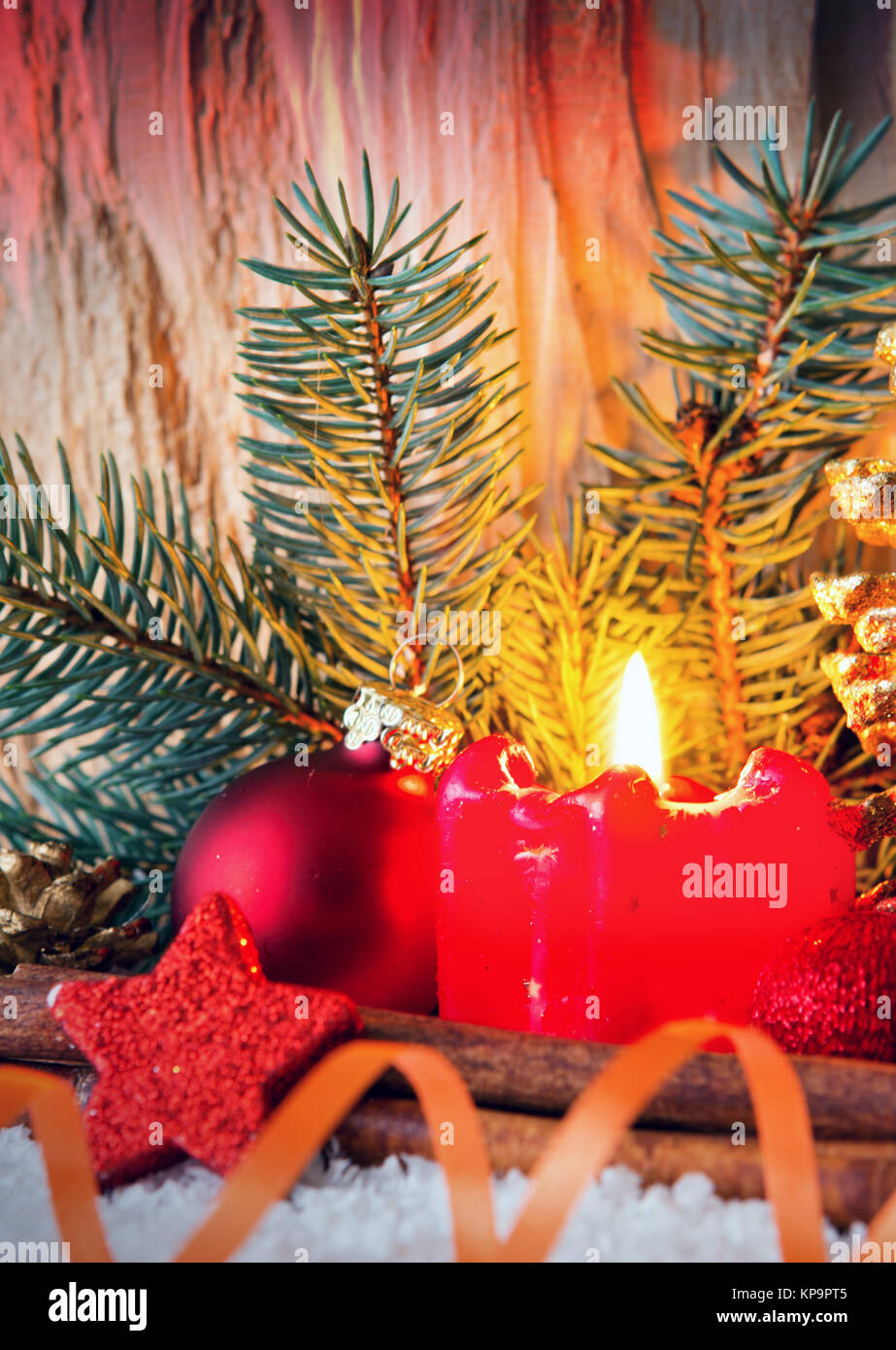 Burning candle, fir tree and Christmas decorations isolated on wooden ...