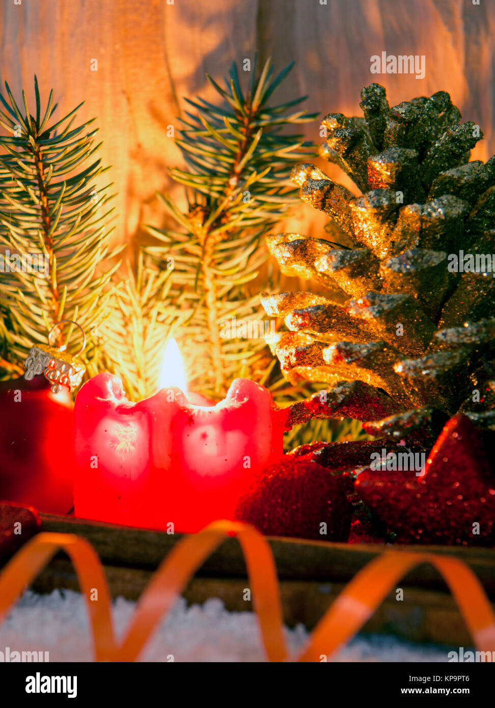 Burning candle, fir tree and Christmas decorations isolated on wooden ...