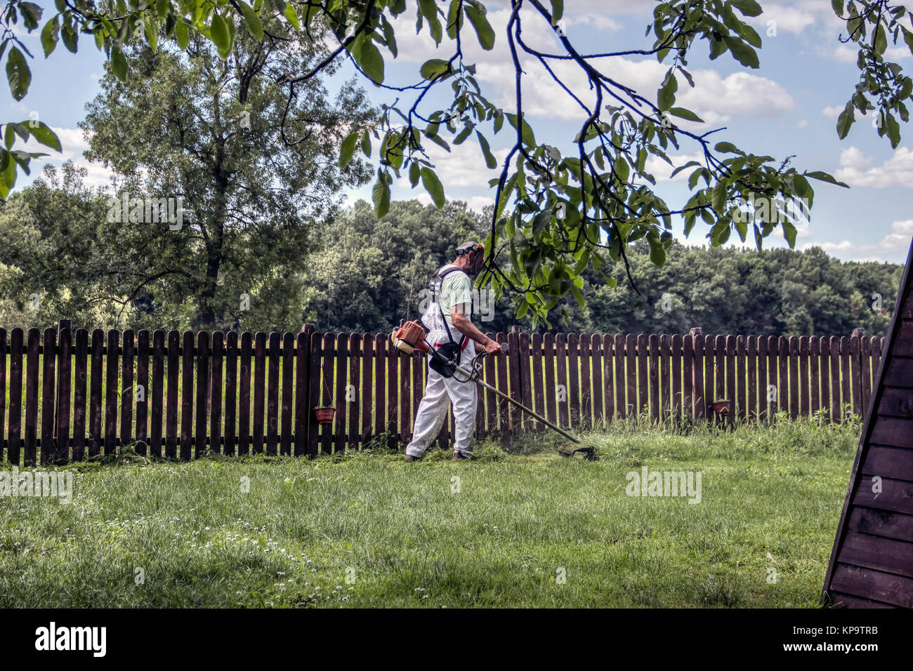 Countryside, Serbia - Man cutting grass Stock Photo