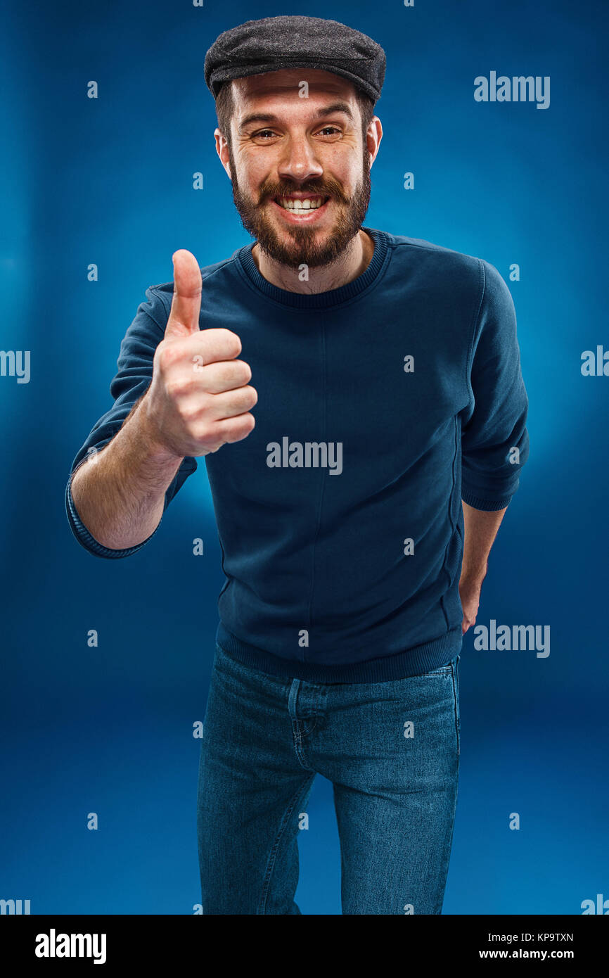 The young man showing the ok thumbs up hand sign Stock Photo - Alamy