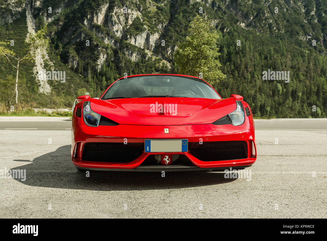DOLOMITI, Lago di Landro, ITALY - SEPTEMBER 10, 2016: Red Ferrari 488 GTB parking on Lago di Landro. The 488GTB is a heavily re-engineered replacement Stock Photo