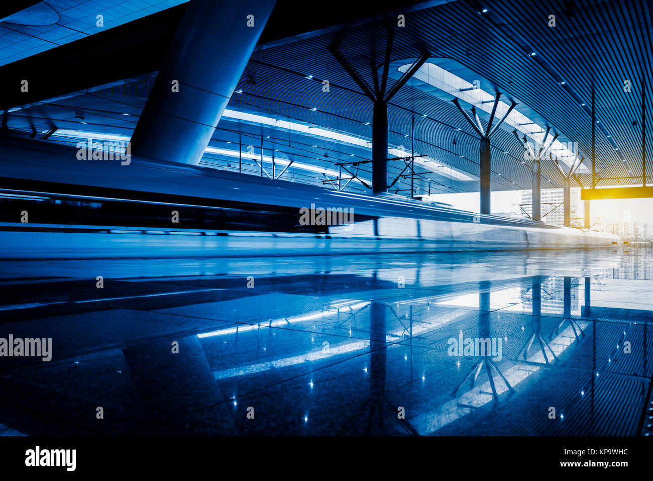 Blurred view of train leaving platform in city of China. Stock Photo