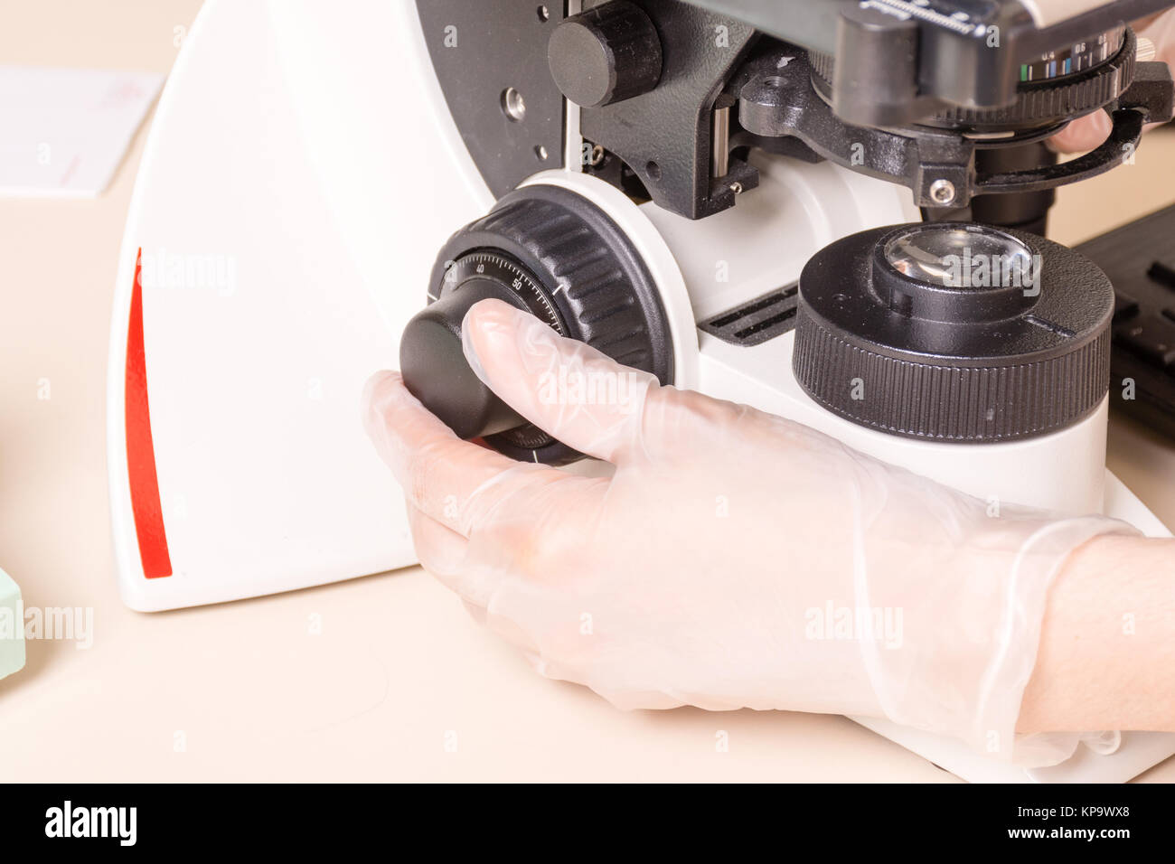 Medical or scientific researcher using a microscope in laboratory ...