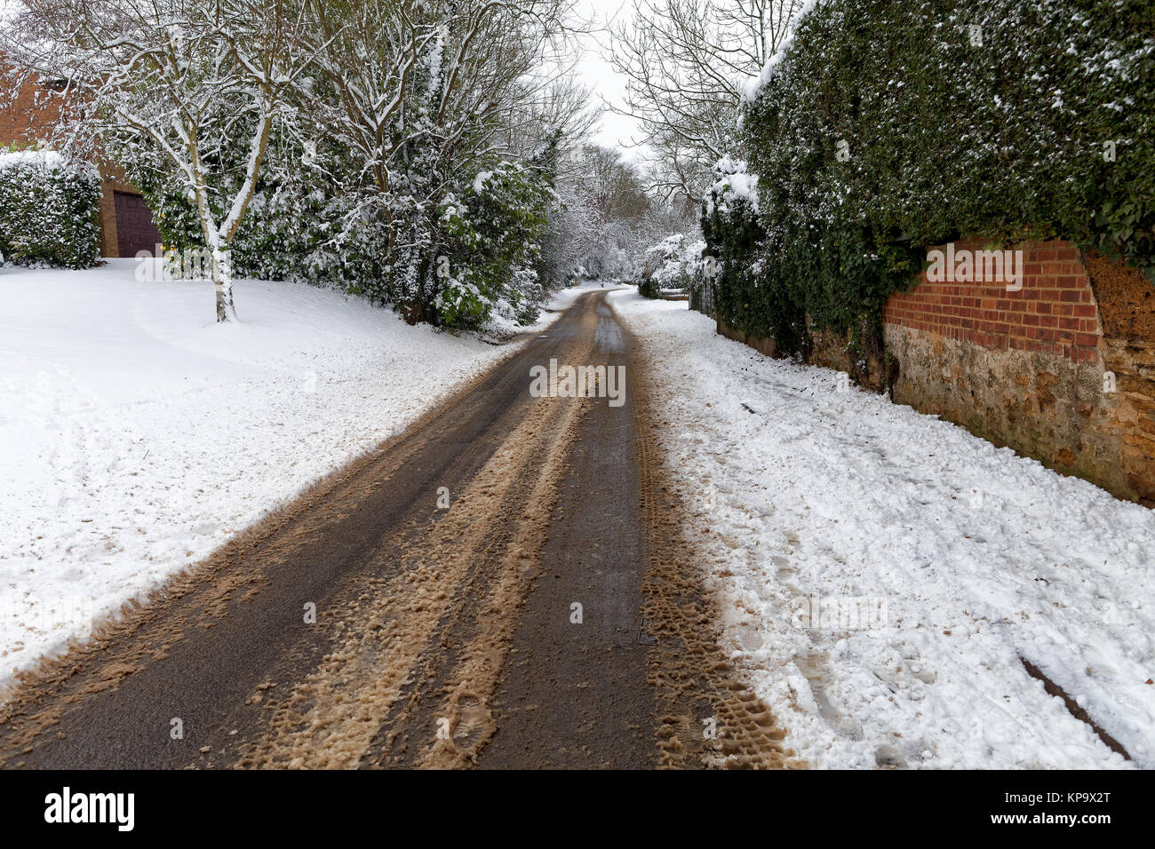 Snow covered road through a small village Stock Photo - Alamy