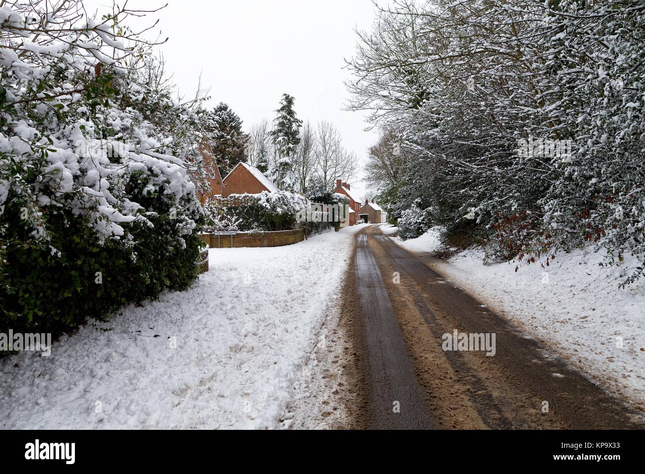 Snow covered road through a small village Stock Photo - Alamy