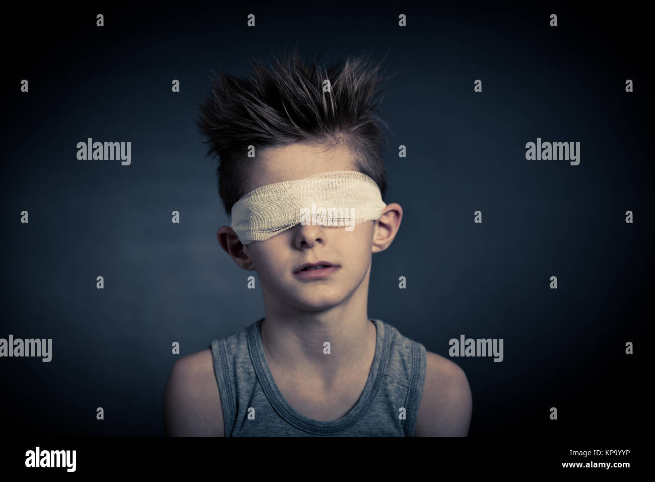 Young Boy with Bandage on Eyes Against Gray Stock Photo Alamy