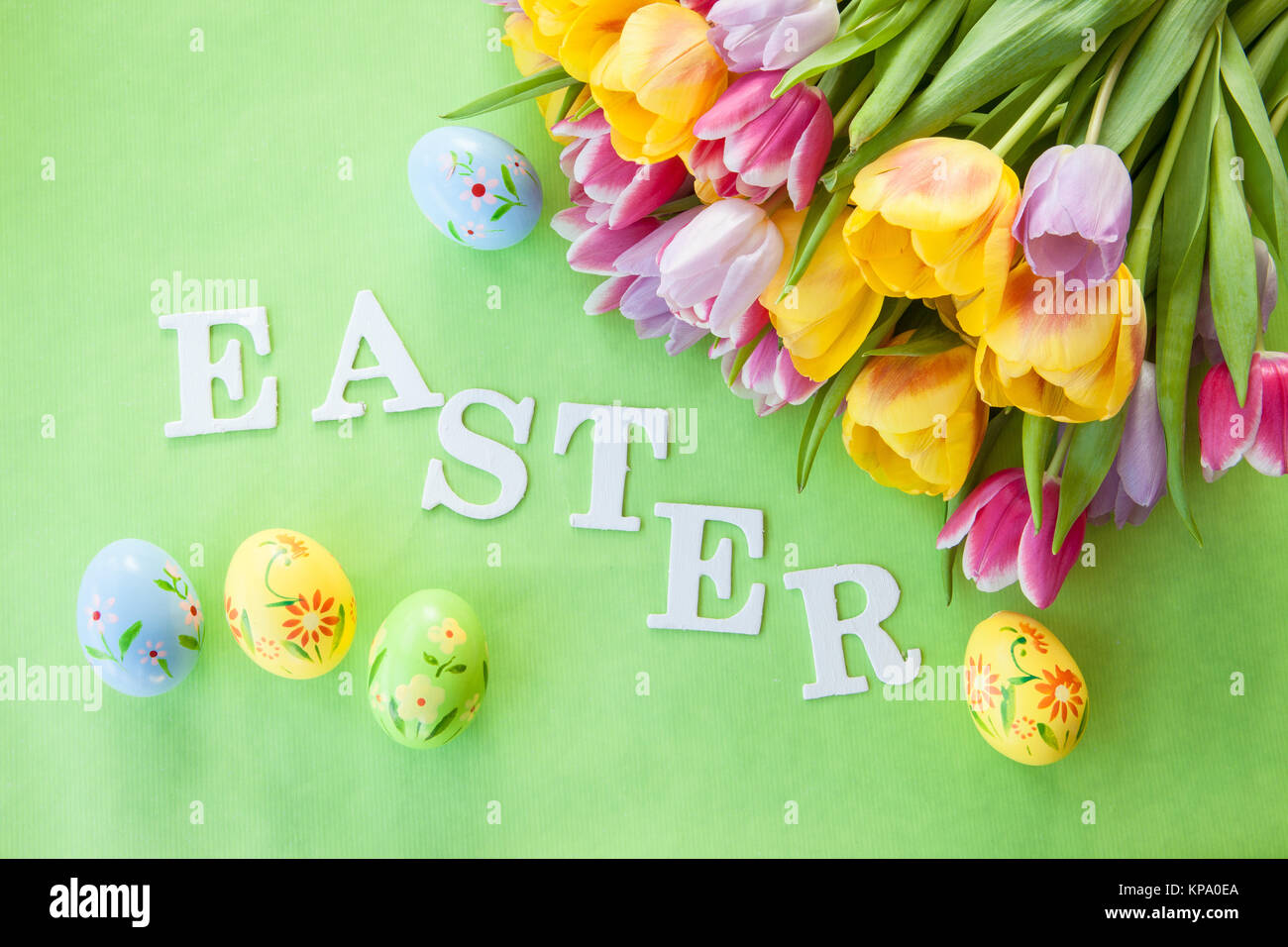 Easter background with tulips and colorful easter eggs Stock Photo - Alamy