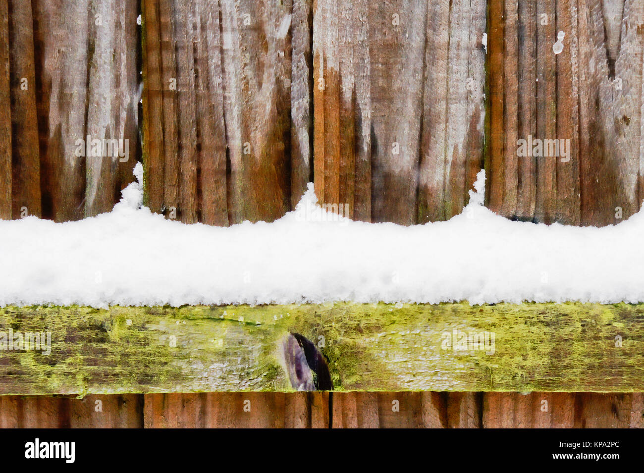 Part of a wooden fence wih snow Stock Photo - Alamy