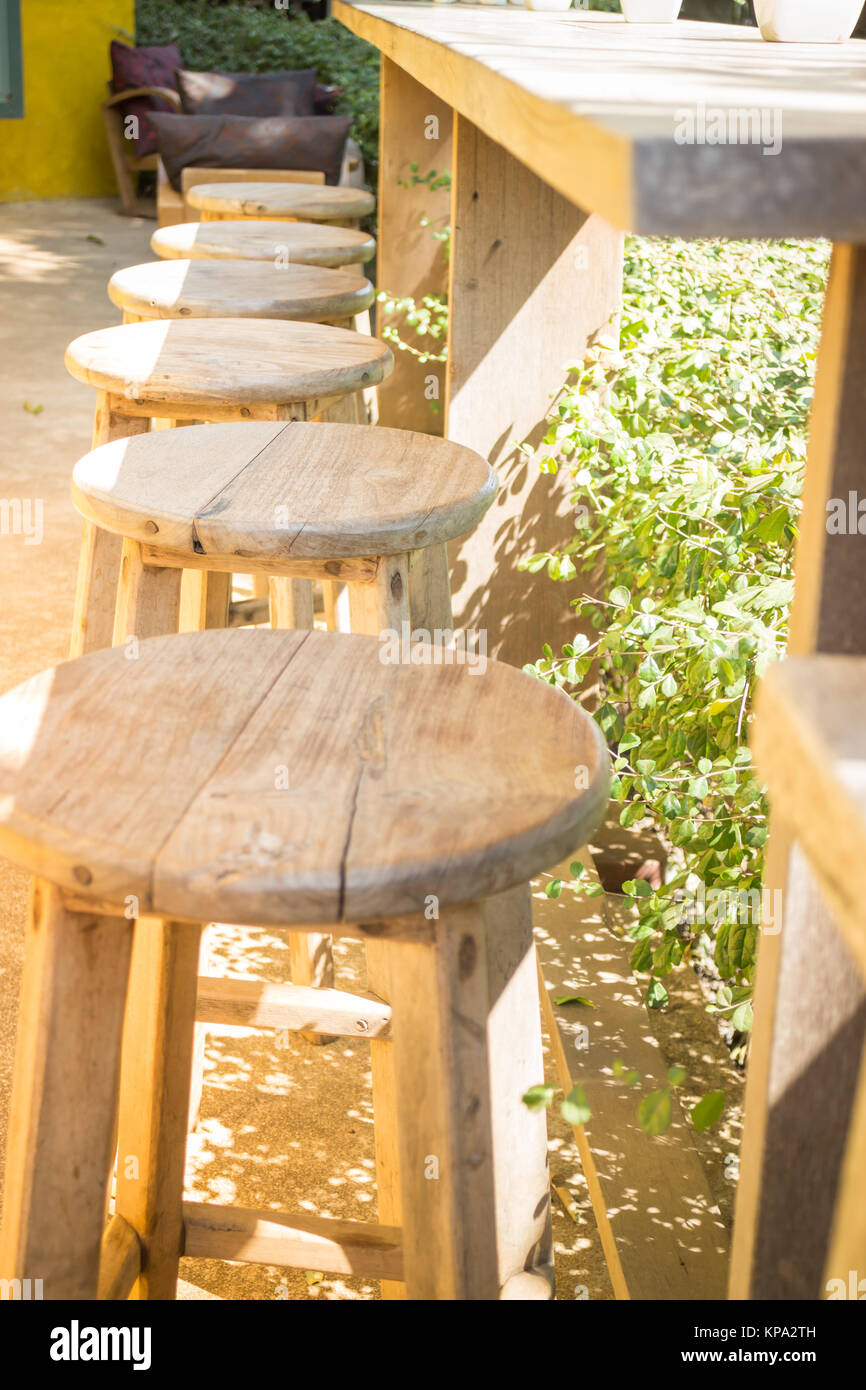 Table and chairs standing in the garden with shadows Stock Photo - Alamy