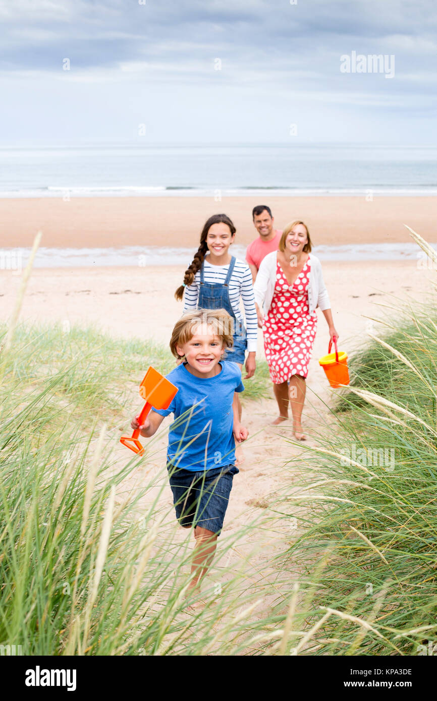 Family walking up the sand dunes Stock Photo