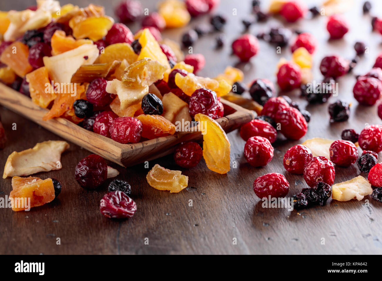Mix of dried fruits and berries on a wooden table Stock Photo - Alamy