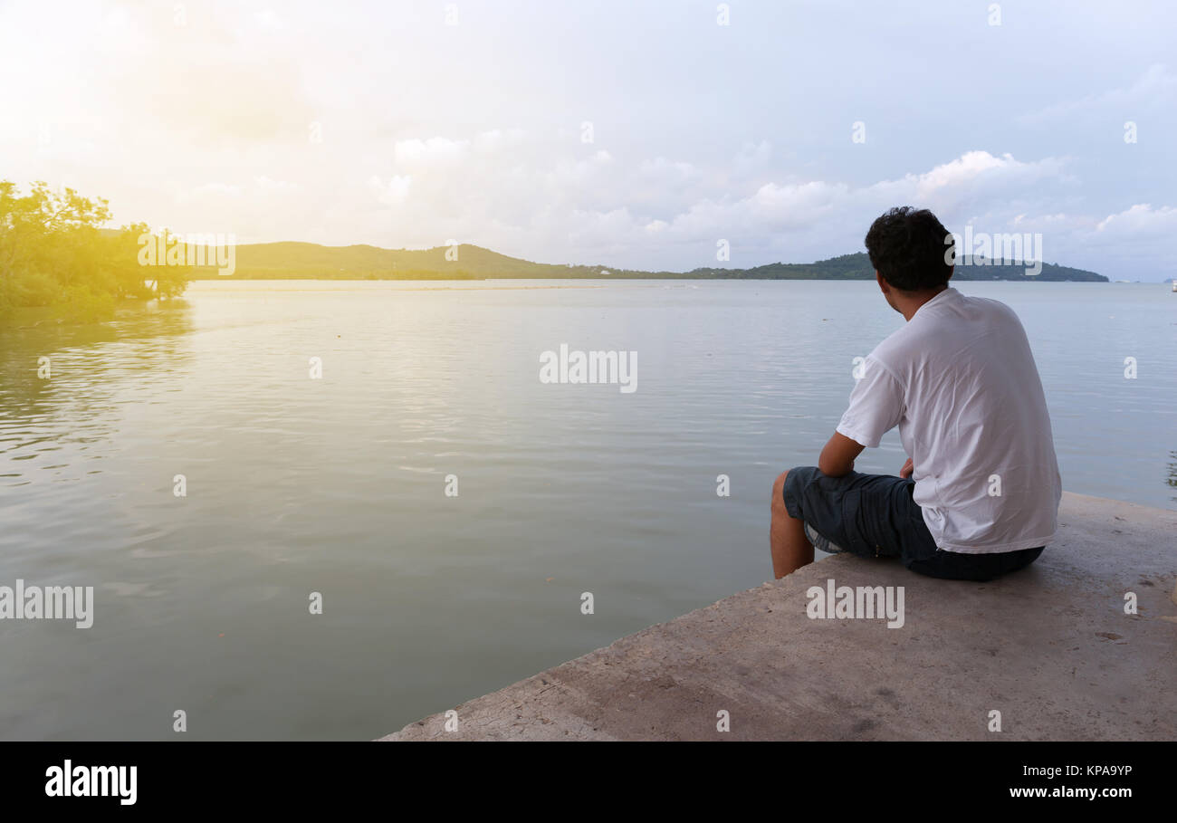Lonely Asian Man Sitting Alone On A Pier On Sea In Phuket Thailand Stock Photo Alamy