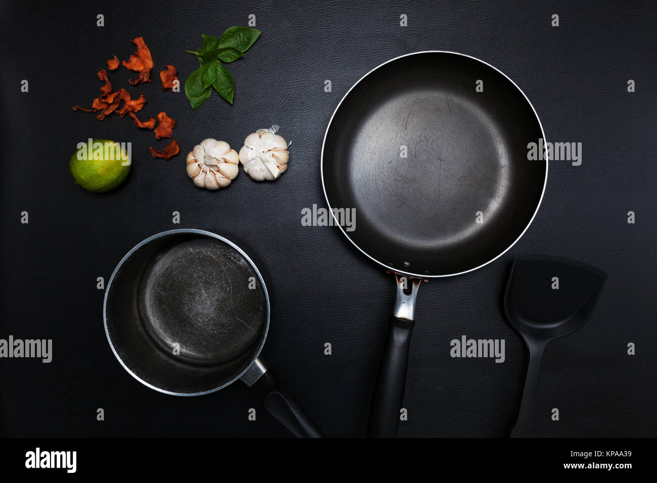 Top view frying pan and pot on black table Stock Photo Alamy