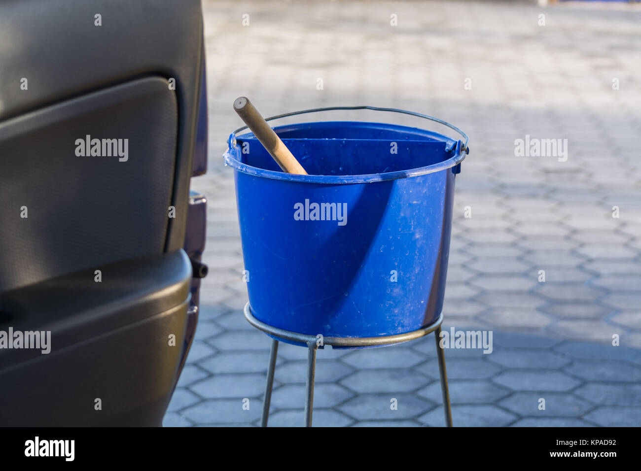 blue bucket with water at a gas station Stock Photo