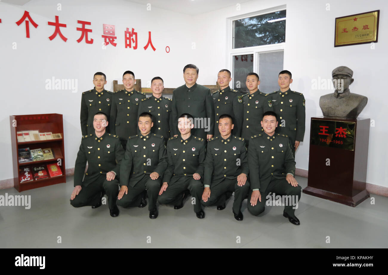 Xuzhou, China's Jiangsu Province. 13th Dec, 2017. Chinese President Xi Jinping (C, rear), also general secretary of the Communist Party of China (CPC) Central Committee and chairman of the Central Military Commission, poses for photos with soldiers of a squad named after the hero soldier Wang Jie, in Xuzhou, east China's Jiangsu Province, Dec. 13, 2017. Xi inspected the 71st Group Army of the People's Liberation Army in Xuzhou on Dec. 13. Credit: Li Gang/Xinhua/Alamy Live News Stock Photo