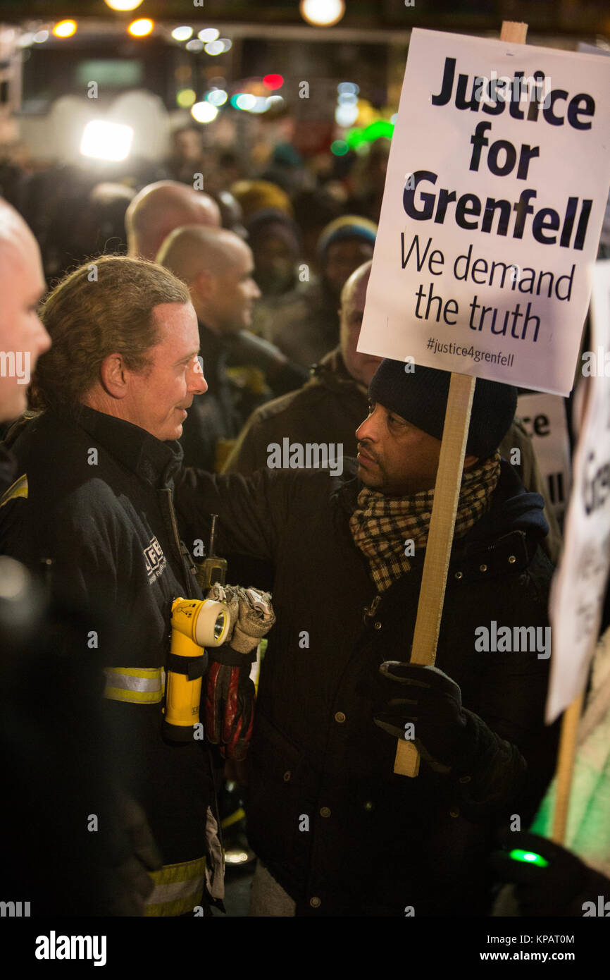 UK. London. North Kensington. Hundreds gather for the Grenfell silent walk held on the 14th of every month in solidarity and support for all those affected by the Grenfell Tower disaster. A man thanks a member of North Kensington Fire Brigade who stood on Ladbroke Grove. December 14th 2017 Photo Credit: ÊZute Lightfoot/Alamy Live News Stock Photo