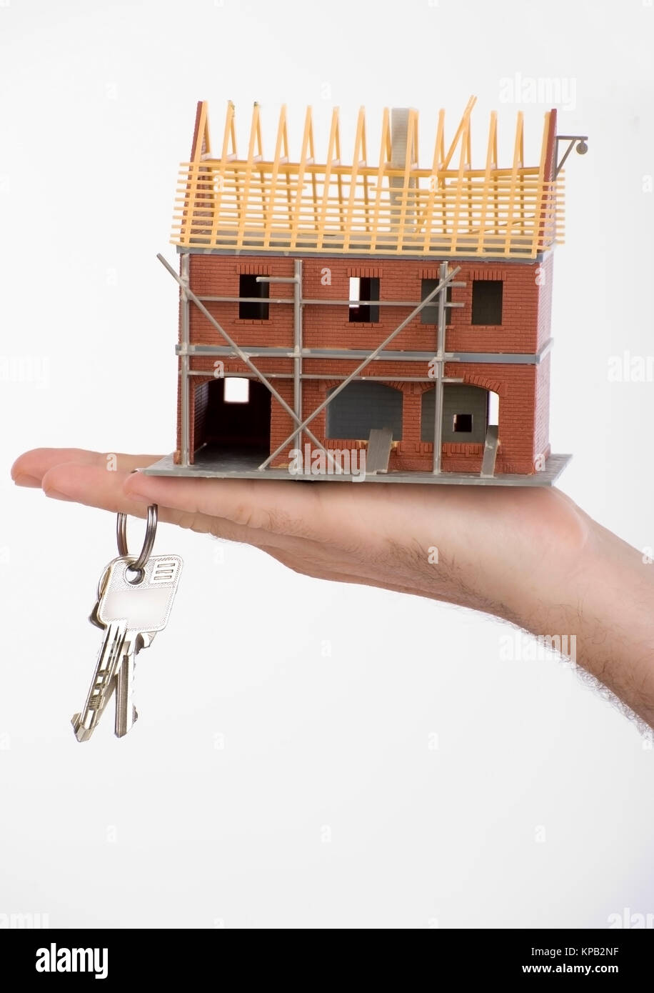 Model release, Rohbau und Schluessel in der Hand, Symbolbild Hausbau - new build house Stock Photo