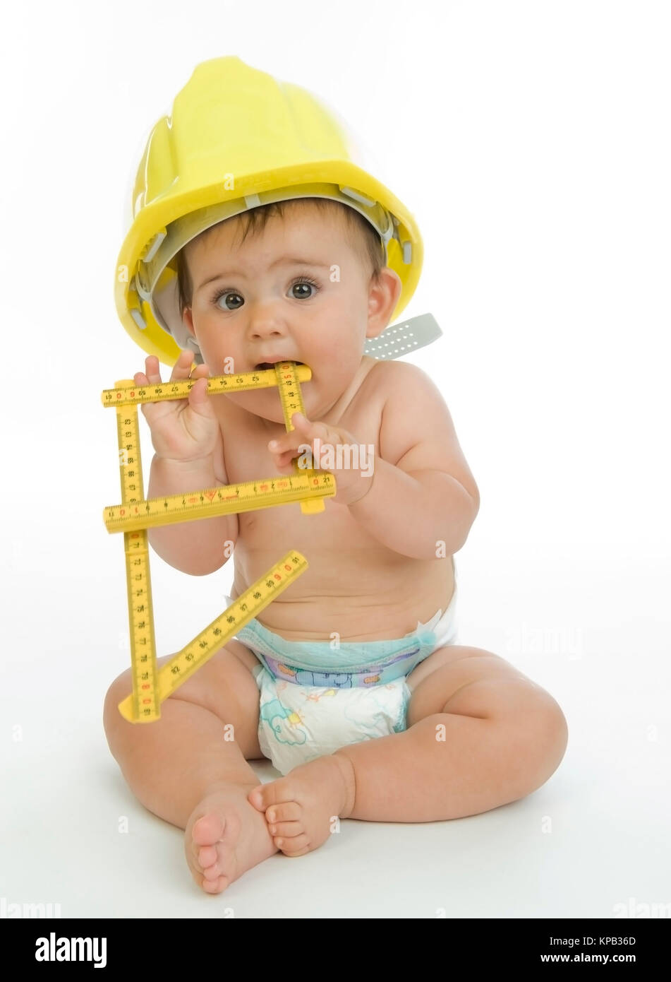 Model release, Kleiner Bauarbeiter mit Zollstock in Windelhose - little child as building worker Stock Photo