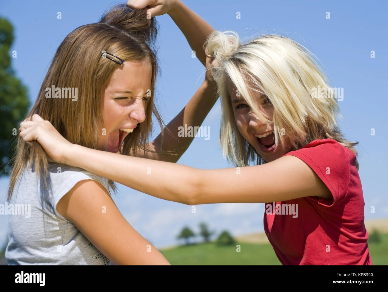 Model release, Zwei Freundinen raufen miteinander - two girl friends fight with each other Stock Photo