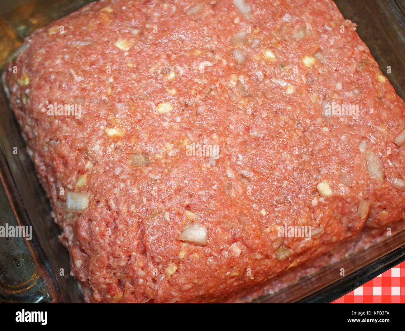 Meatloaf using lean ground beef, onions, crushed crackers and seasonings in a casserole dish ready for cooking Stock Photo