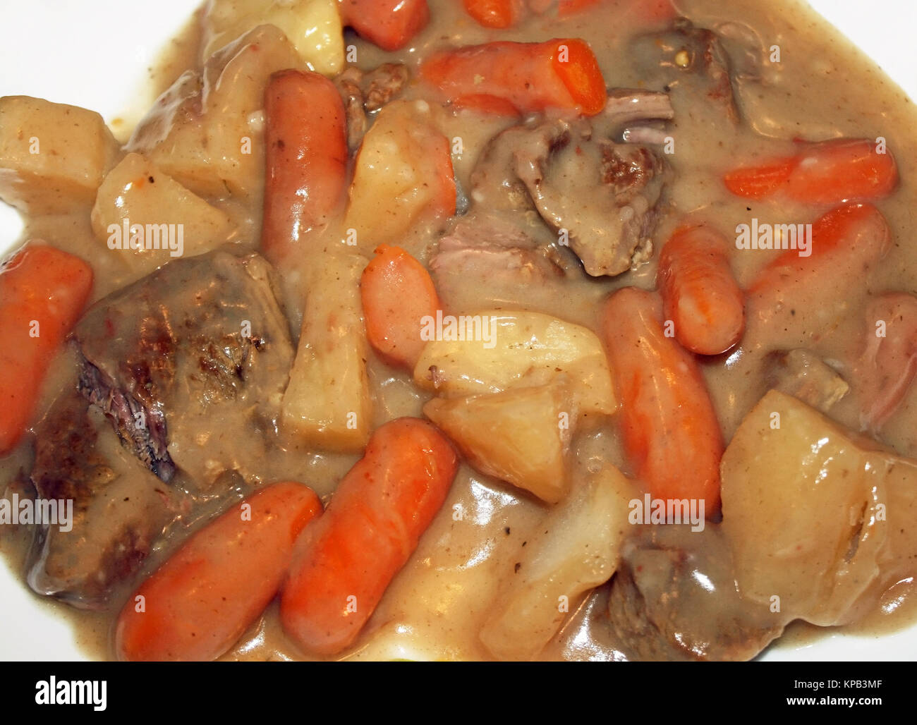 Crock Pot Beef Stew with carrots, potatoes, lean stewing beef in a rich thick gravy Stock Photo