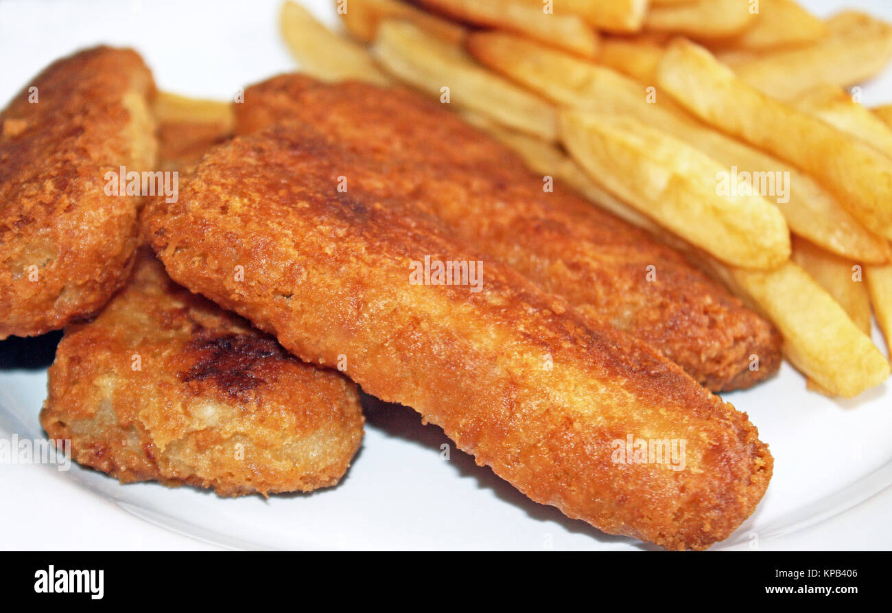 Oven baked Golden brown Fish Sticks with oven baked french fries on the side Stock Photo