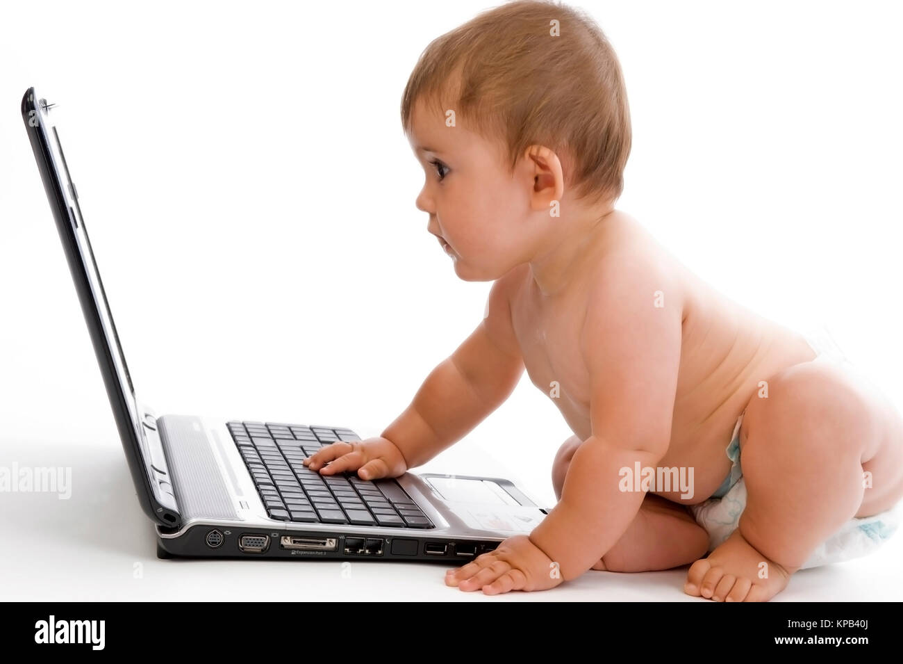 Model release, Kleinkind, 8 Monate, arbeitet am Laptop - little child using laptop Stock Photo