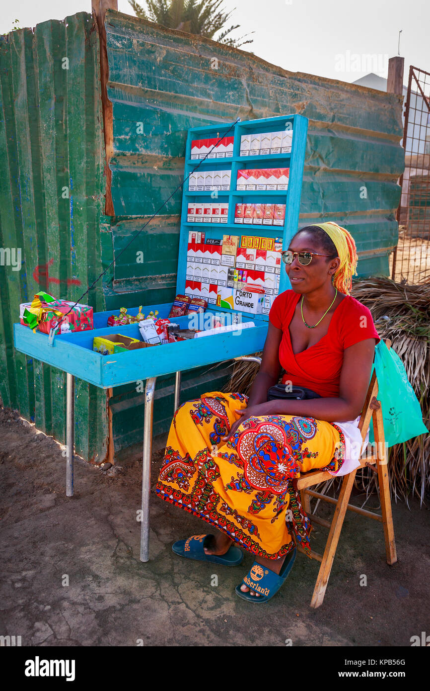 Woman selling cigarettes and tobacco at a street corner from a stall in  Santa Maria, Sal Island, Salina, Cape Verde, Africa Stock Photo